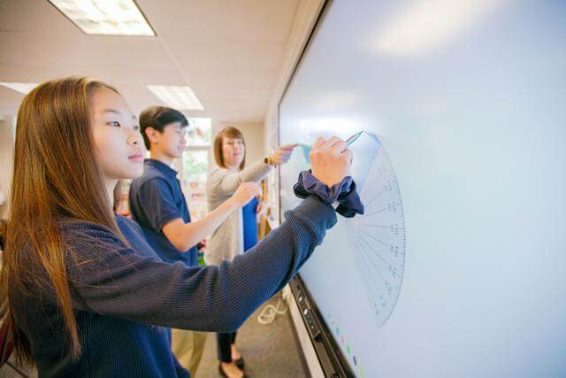Students and teacher with protractor at ActivPanel